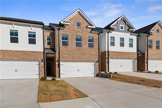 8147 Tiger Way, Riverdale, GA 30296 - view of front facade with brick siding, an attached garage, and driveway