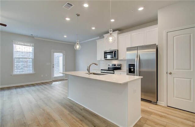 8147 Tiger Way, Riverdale, GA 30296 - kitchen with appliances with stainless steel finishes, a sink, a kitchen island with sink, light wood-type flooring, and white cabinetry