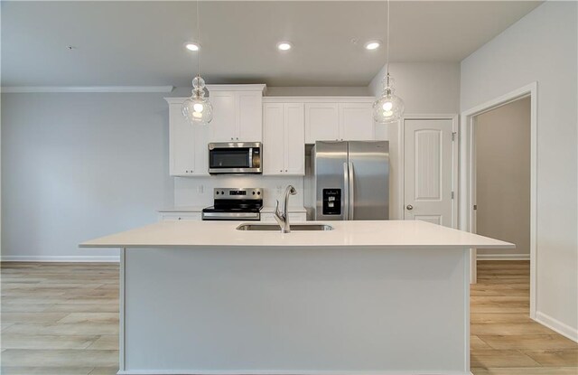 8147 Tiger Way, Riverdale, GA 30296 - kitchen featuring stainless steel appliances, a sink, baseboards, light wood-style flooring, and white cabinets