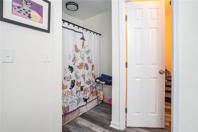 bathroom featuring curtained shower and hardwood / wood-style floors