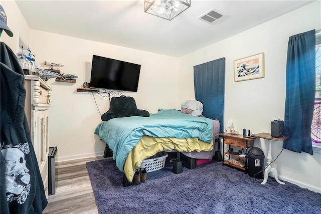 bedroom with wood-type flooring