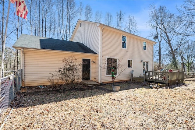 rear view of property featuring a deck