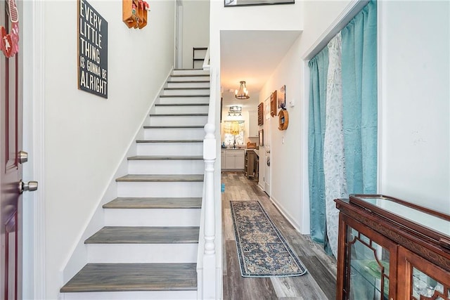 stairs featuring hardwood / wood-style flooring