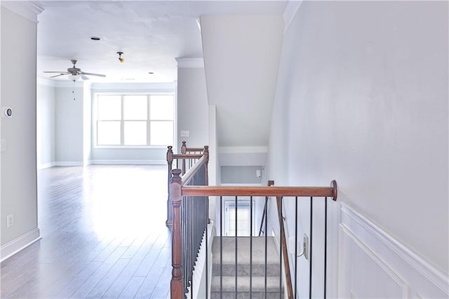 stairs with crown molding, ceiling fan, and hardwood / wood-style floors