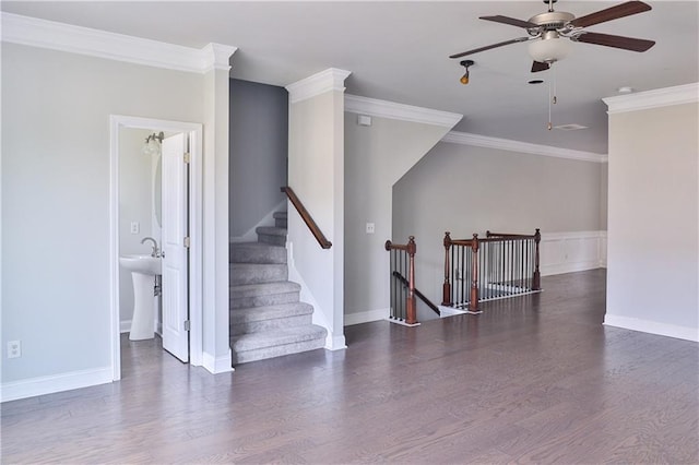 empty room featuring dark wood-type flooring, ceiling fan, and crown molding