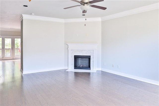 unfurnished living room featuring ornamental molding, wood-type flooring, ceiling fan, and french doors