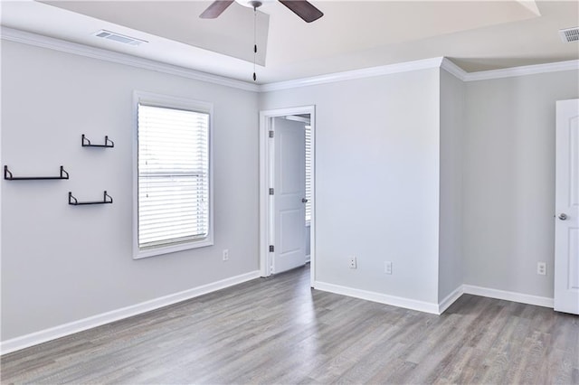 empty room with crown molding, ceiling fan, and light hardwood / wood-style flooring