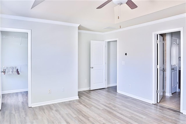 unfurnished bedroom featuring ornamental molding, light hardwood / wood-style floors, and a closet