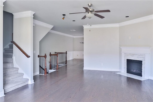 living room with crown molding, dark wood-type flooring, and ceiling fan