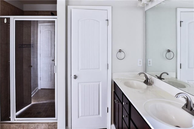 bathroom featuring vanity and an enclosed shower