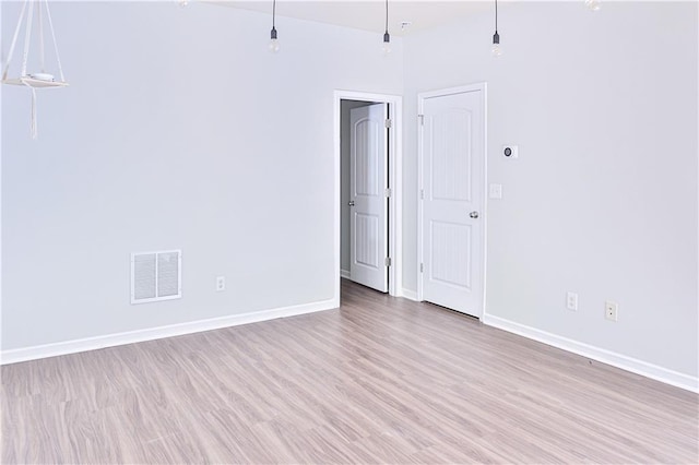 spare room featuring light hardwood / wood-style floors