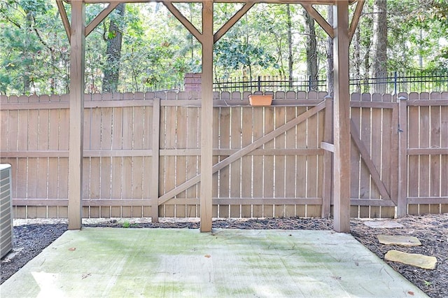 view of gate featuring a patio