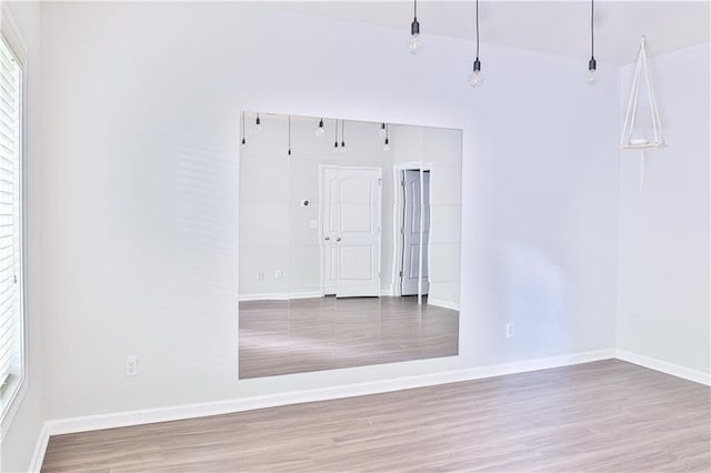 unfurnished room featuring hardwood / wood-style flooring