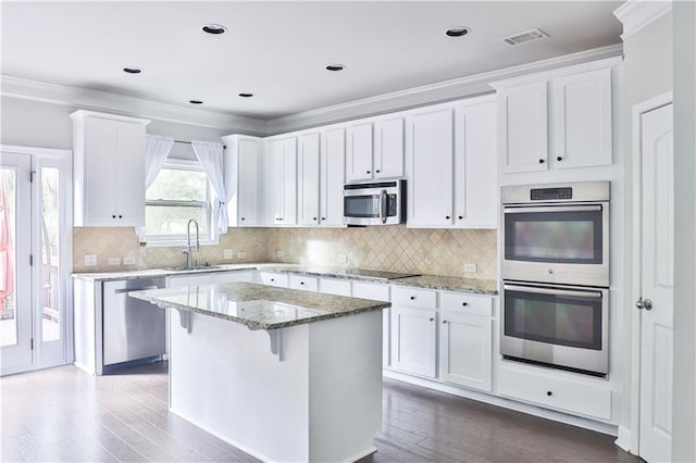 kitchen with white cabinetry, sink, a center island, and appliances with stainless steel finishes