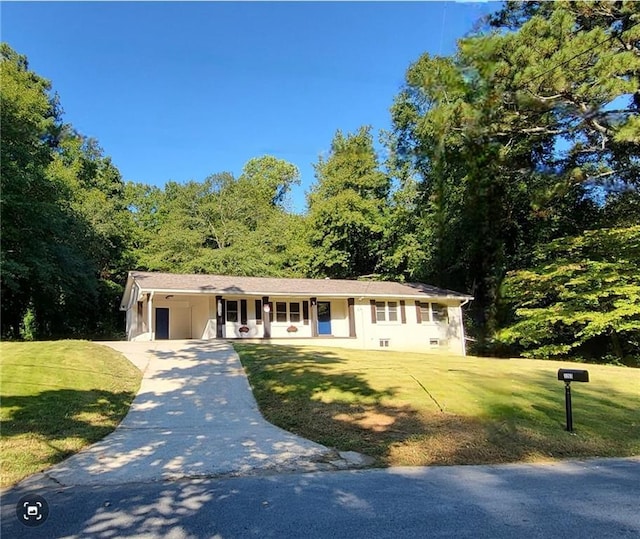 ranch-style house featuring a porch, driveway, and a front lawn