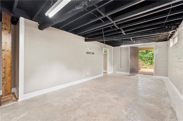 garage with concrete block wall and baseboards