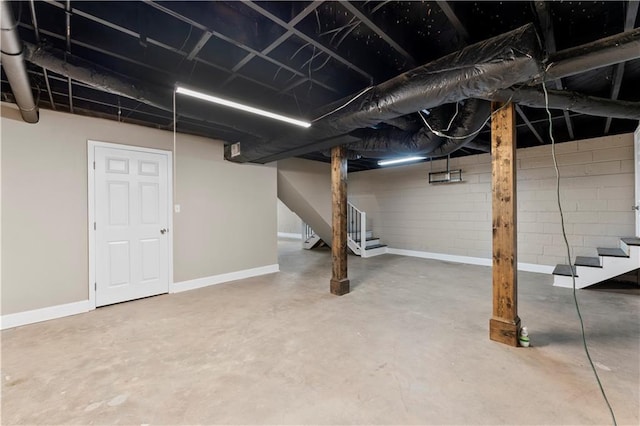 unfinished below grade area with stairway and baseboards