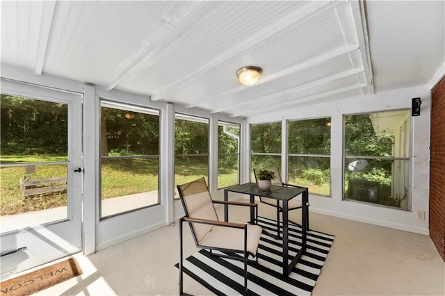 sunroom featuring beam ceiling