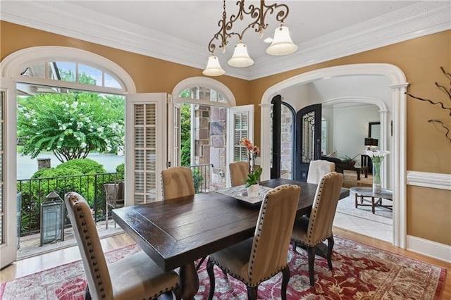 dining area featuring a notable chandelier and crown molding