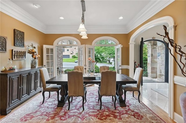 dining area with light tile patterned floors and ornamental molding