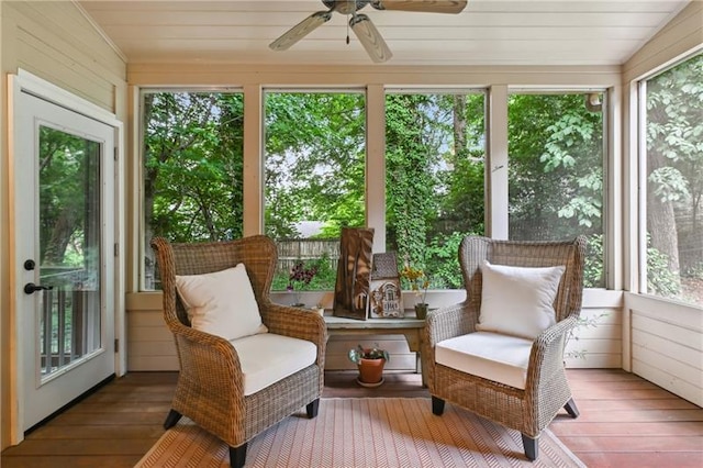 sunroom with ceiling fan and vaulted ceiling