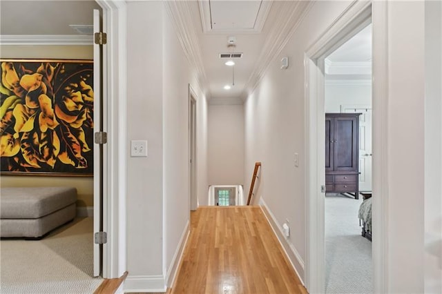 hall featuring ornamental molding and carpet