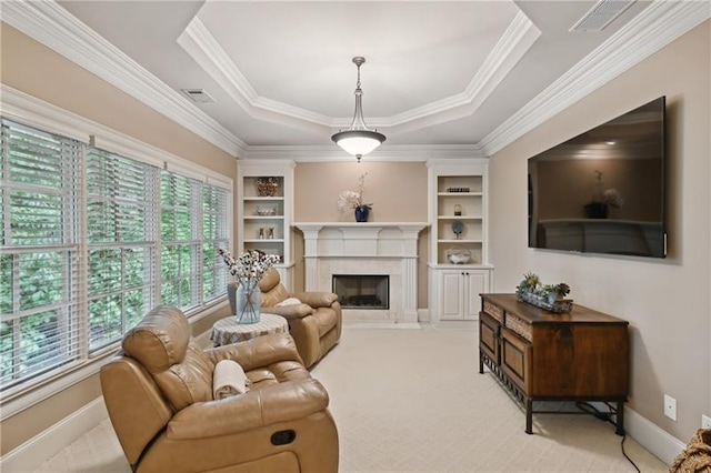 living room with light carpet, ornamental molding, built in features, and a raised ceiling