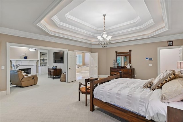 carpeted bedroom with ensuite bathroom, a chandelier, crown molding, and a tray ceiling