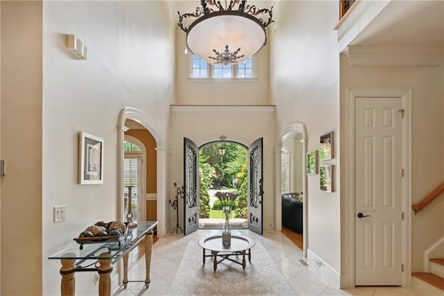 tiled foyer featuring a towering ceiling