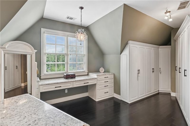 interior space featuring dark hardwood / wood-style floors, lofted ceiling, and a chandelier