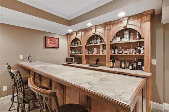 bar featuring ornamental molding and sink