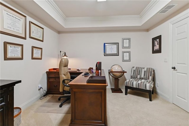 home office featuring light colored carpet, a tray ceiling, and ornamental molding