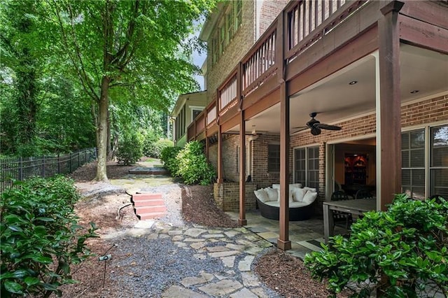 view of patio / terrace with ceiling fan and an outdoor living space