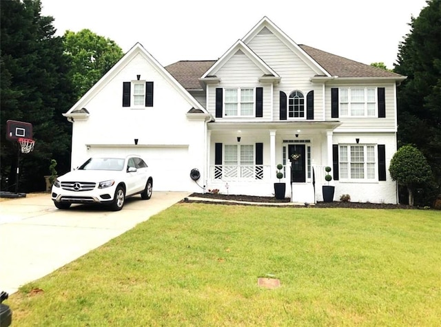 6265 Lake Windsor Pkwy, Buford, GA 30518 - view of front of house with a porch, an attached garage, driveway, a front yard, and roof with shingles