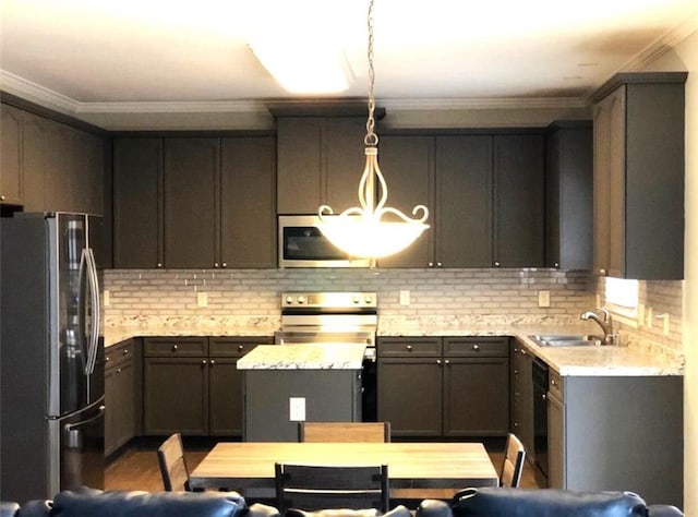 6265 Lake Windsor Pkwy, Buford, GA 30518 - kitchen featuring appliances with stainless steel finishes, tasteful backsplash, ornamental molding, a center island, and hanging light fixtures