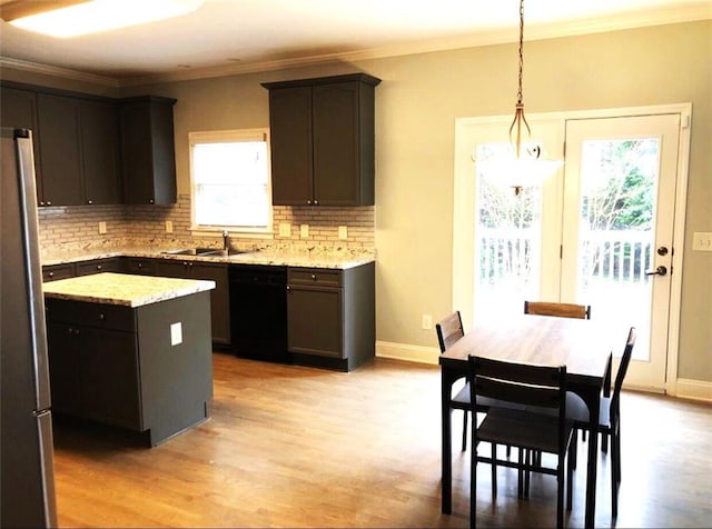 6265 Lake Windsor Pkwy, Buford, GA 30518 - kitchen featuring dishwasher, light wood-style flooring, decorative backsplash, ornamental molding, and a kitchen island