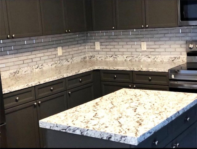 6265 Lake Windsor Pkwy, Buford, GA 30518 - kitchen featuring stainless steel appliances, tasteful backsplash, and light stone countertops
