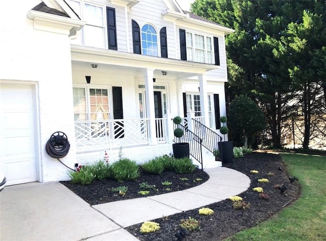 6265 Lake Windsor Pkwy, Buford, GA 30518 - property entrance with covered porch and a garage