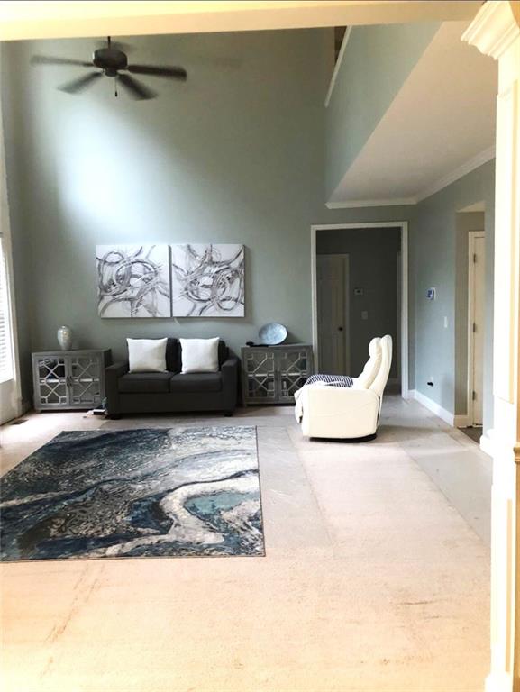 6265 Lake Windsor Pkwy, Buford, GA 30518 - carpeted living area featuring ornamental molding and ceiling fan
