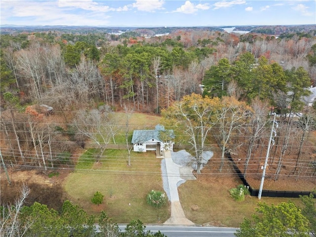 birds eye view of property featuring a view of trees
