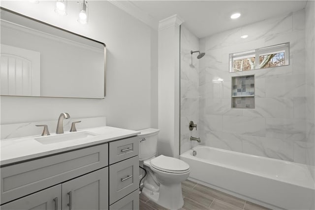 full bathroom featuring crown molding, vanity, toilet, and bathing tub / shower combination