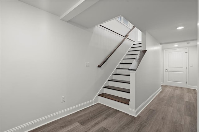 stairs with baseboards, recessed lighting, and wood finished floors