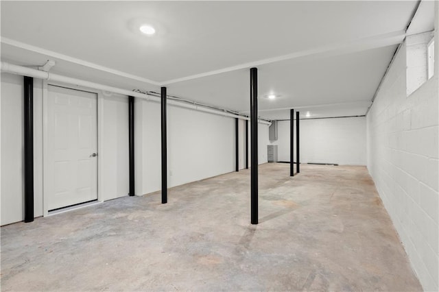 finished below grade area featuring concrete block wall