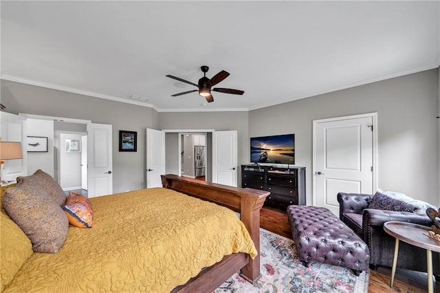 bedroom featuring ceiling fan, hardwood / wood-style floors, and ornamental molding