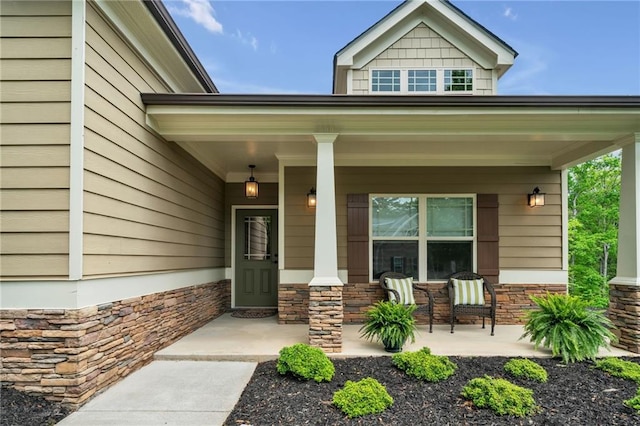 view of exterior entry featuring a porch