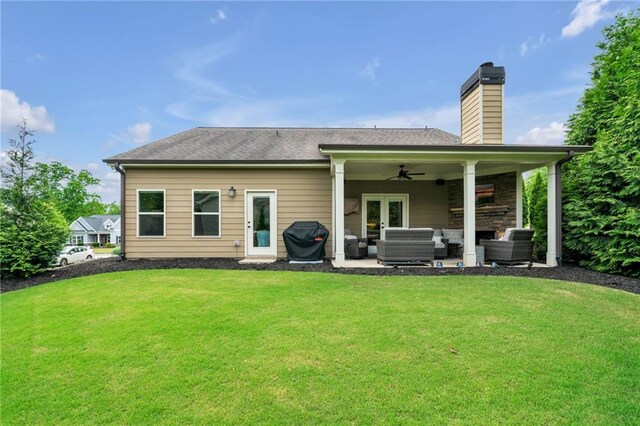 back of property featuring an outdoor hangout area, ceiling fan, a patio area, and a lawn