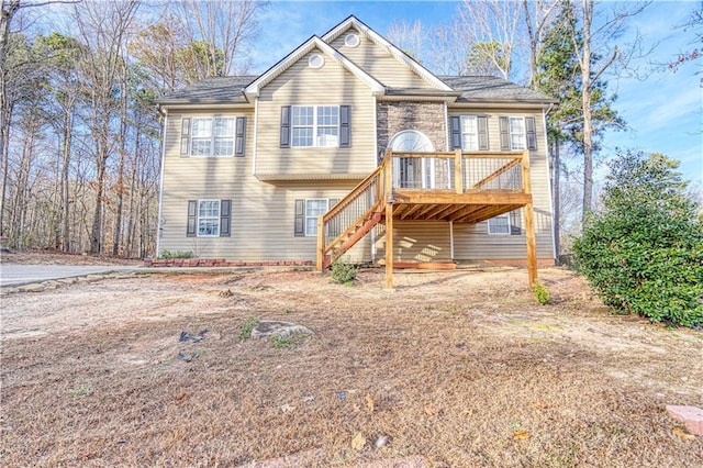 bi-level home featuring a deck and stairway