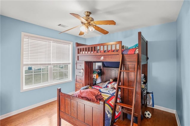 bedroom featuring light wood-style floors, baseboards, and visible vents