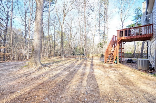 view of yard with a deck, cooling unit, and stairway