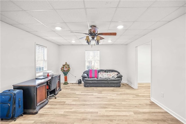 office space with light wood-style flooring, baseboards, a drop ceiling, and recessed lighting